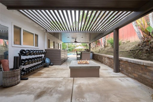 view of patio featuring an outdoor fire pit and a pergola