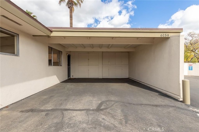 garage featuring a carport