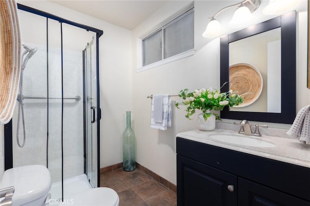 bathroom with tile patterned floors, toilet, baseboards, a shower stall, and vanity