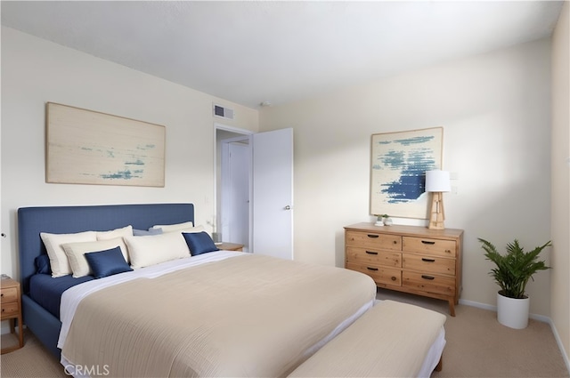 carpeted bedroom featuring baseboards and visible vents