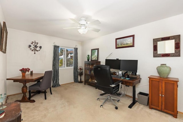 home office with a ceiling fan and light colored carpet