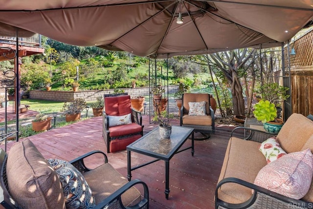 view of patio with outdoor lounge area, fence, and a wooden deck