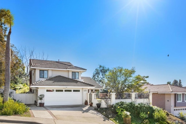 view of front of property featuring fence, an attached garage, stucco siding, concrete driveway, and a tile roof