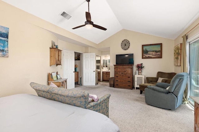 bedroom with visible vents, ceiling fan, light colored carpet, vaulted ceiling, and ensuite bath