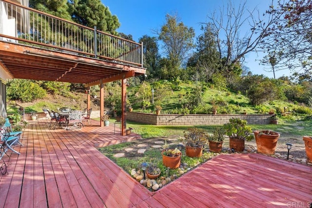 wooden terrace featuring outdoor dining area