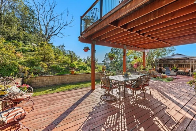 deck with outdoor dining area and fence