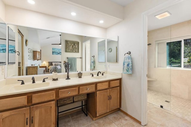 bathroom featuring double vanity, ceiling fan, walk in shower, and a sink