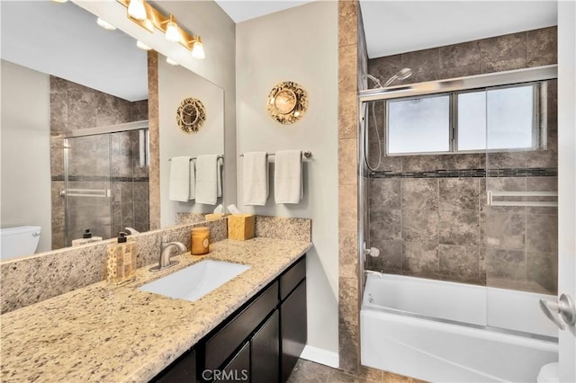 bathroom with vanity, tile patterned floors, toilet, and enclosed tub / shower combo