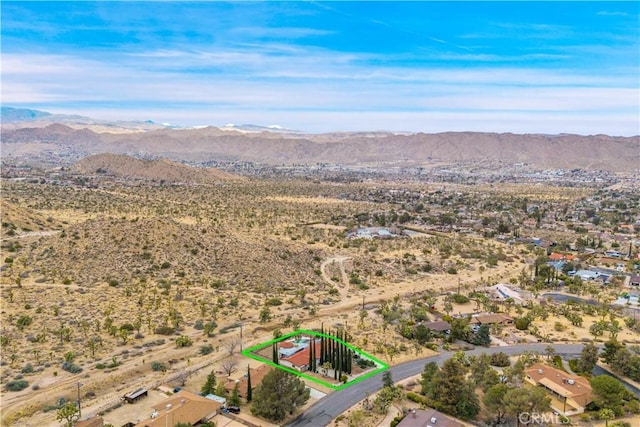 birds eye view of property featuring a mountain view and a desert view