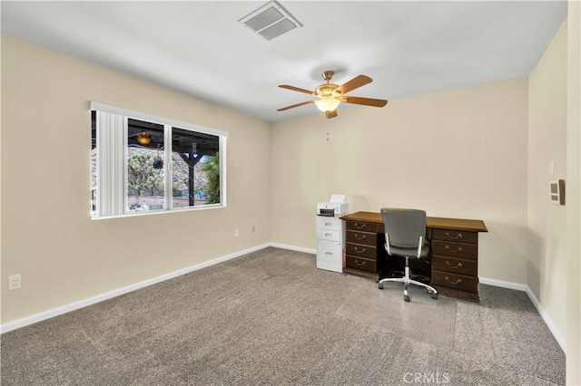 unfurnished office featuring visible vents, ceiling fan, baseboards, and carpet floors