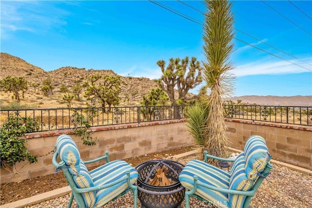 view of patio with a mountain view and a fenced backyard