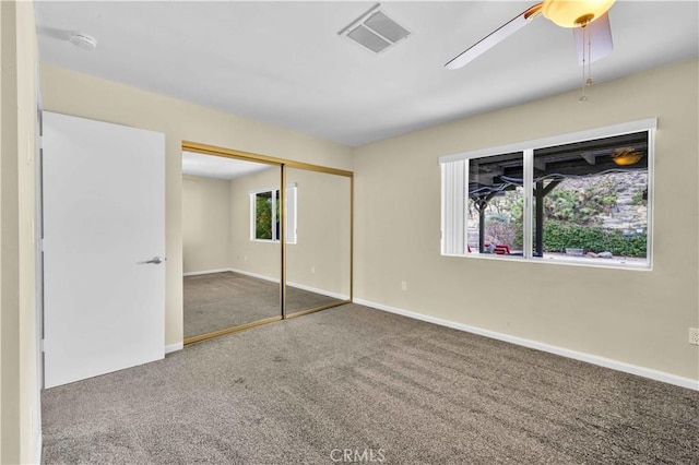 unfurnished bedroom with visible vents, baseboards, carpet, and a ceiling fan