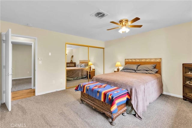 bedroom with a closet, visible vents, baseboards, and carpet