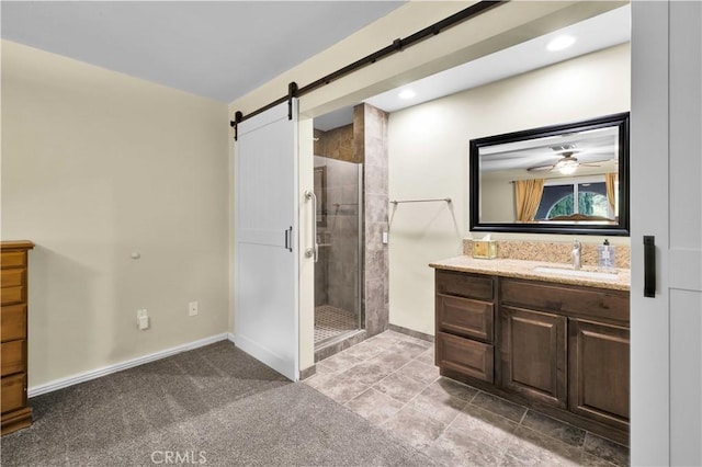 bathroom featuring recessed lighting, a shower stall, vanity, and baseboards