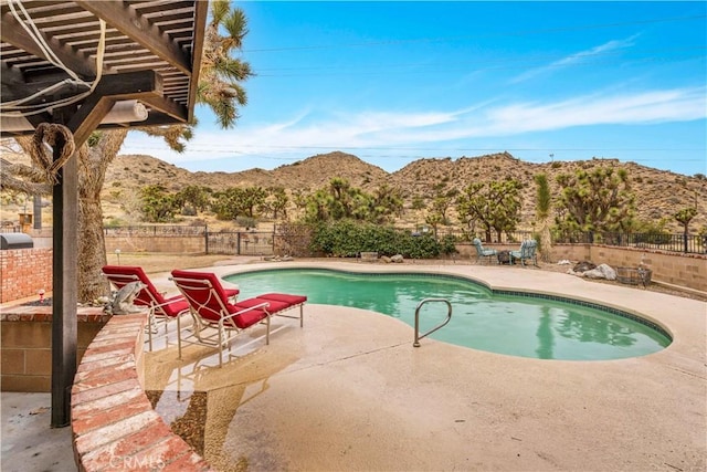 view of pool featuring a fenced in pool, a fenced backyard, a mountain view, a pergola, and a patio