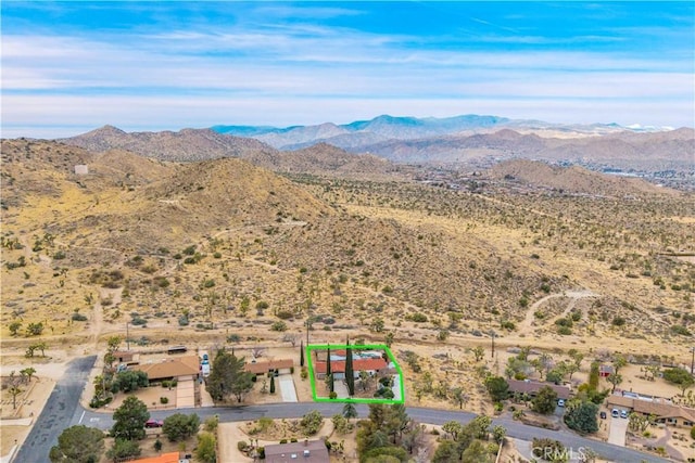 birds eye view of property featuring view of desert and a mountain view