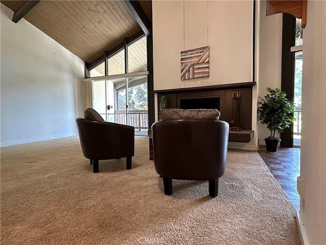 living area featuring beamed ceiling, a fireplace, baseboards, and high vaulted ceiling