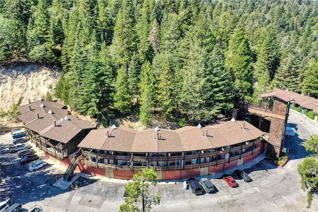 birds eye view of property featuring a view of trees