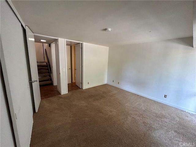 unfurnished bedroom with carpet flooring and baseboards