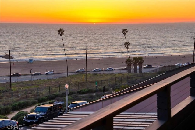 property view of water with fence and a beach view