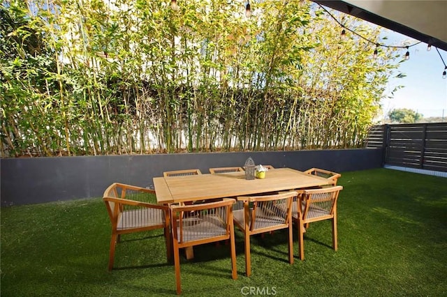 view of patio with outdoor dining space and a fenced backyard