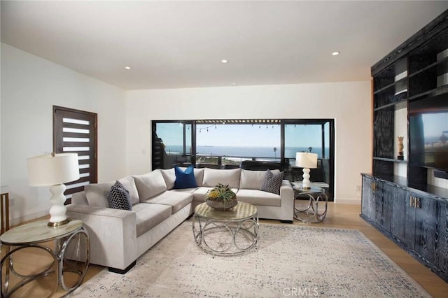 living room featuring wood finished floors, recessed lighting, and baseboards