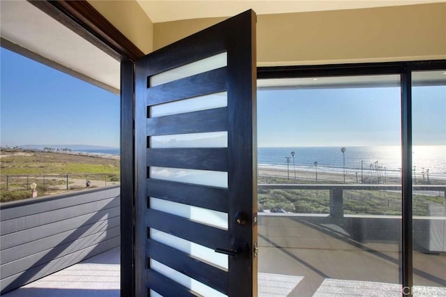 interior space featuring a wealth of natural light and a water view