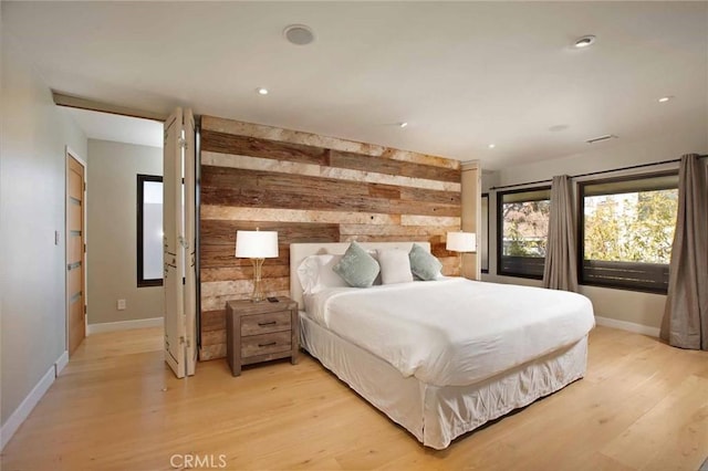 bedroom featuring recessed lighting, baseboards, and light wood-style flooring