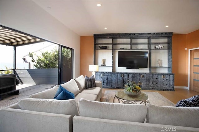 living room featuring recessed lighting, baseboards, and wood finished floors