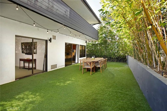 view of yard featuring visible vents and fence