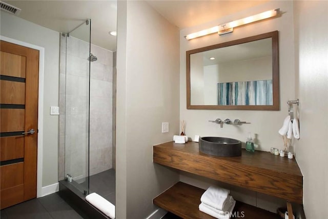 bathroom with vanity, visible vents, and a stall shower