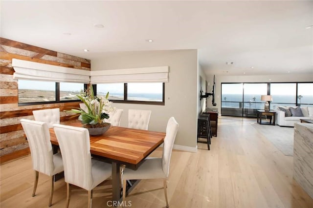 dining area with light wood finished floors and recessed lighting