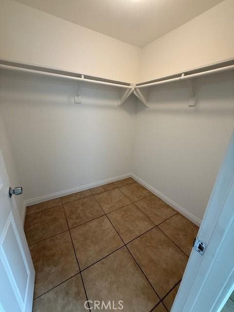 walk in closet with tile patterned flooring