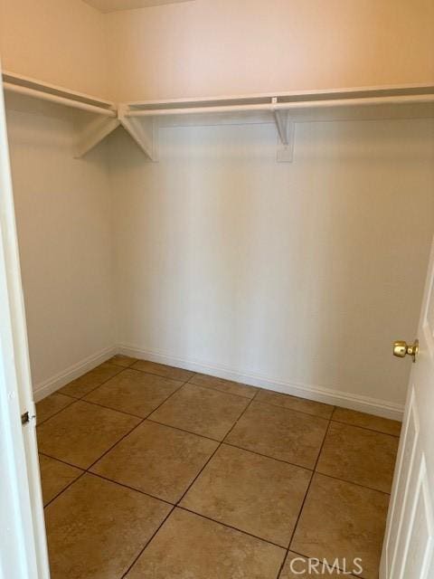 walk in closet featuring tile patterned flooring