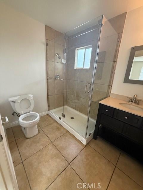 bathroom featuring tile patterned floors, a shower stall, toilet, and baseboards