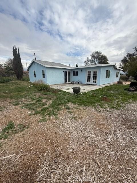 rear view of property with french doors and a patio