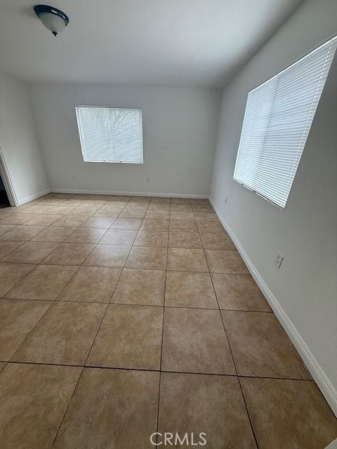 tiled spare room with baseboards