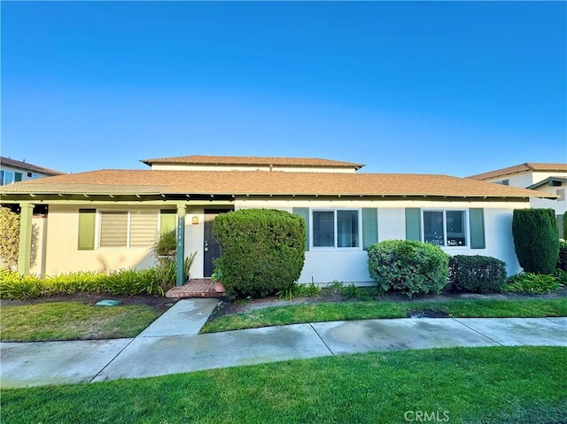 view of front of property with stucco siding and a front yard