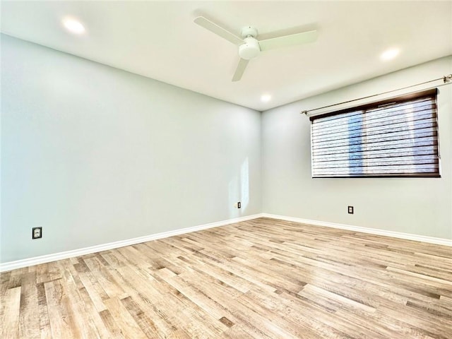 spare room with recessed lighting, light wood-type flooring, baseboards, and a ceiling fan