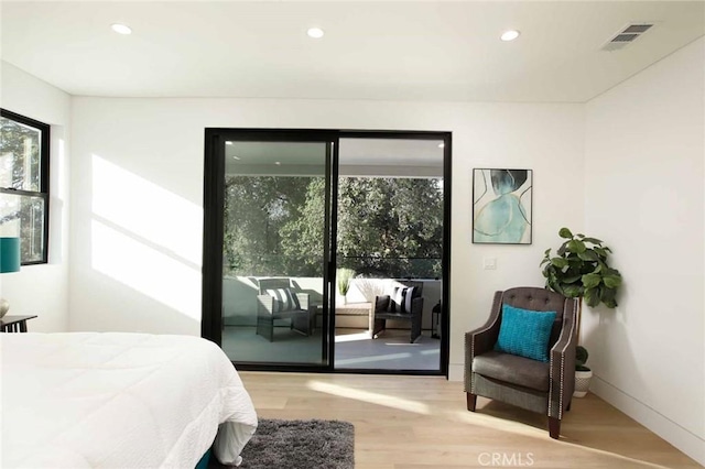 bedroom with access to exterior, visible vents, baseboards, recessed lighting, and wood finished floors