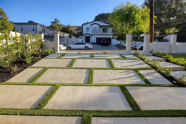 view of parking / parking lot with fence and driveway