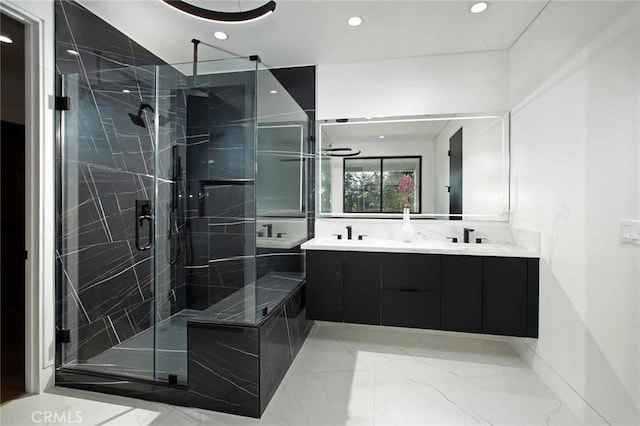 bathroom featuring double vanity, recessed lighting, a stall shower, marble finish floor, and a sink