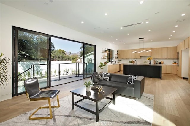 living room featuring recessed lighting and light wood finished floors