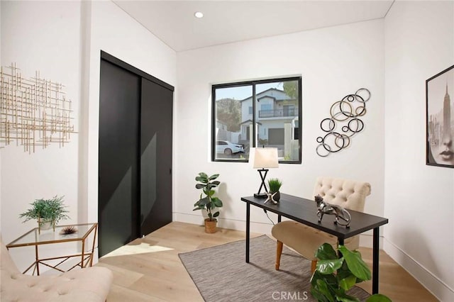 office space with recessed lighting, baseboards, and light wood-style floors