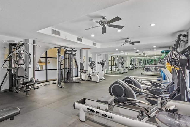 gym with recessed lighting, visible vents, and a textured ceiling