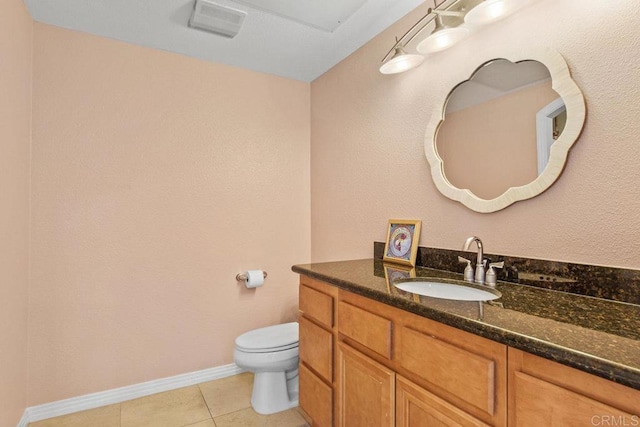 half bathroom with visible vents, baseboards, toilet, tile patterned floors, and vanity