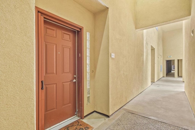 entrance to property featuring stucco siding