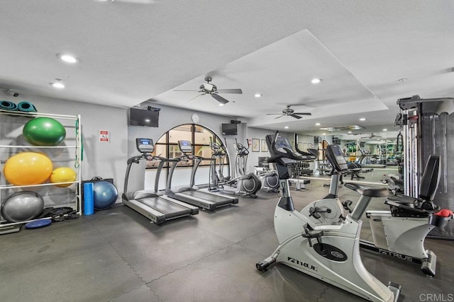 exercise room with recessed lighting and a textured ceiling