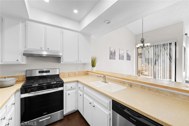 kitchen with under cabinet range hood, light countertops, appliances with stainless steel finishes, white cabinetry, and a sink