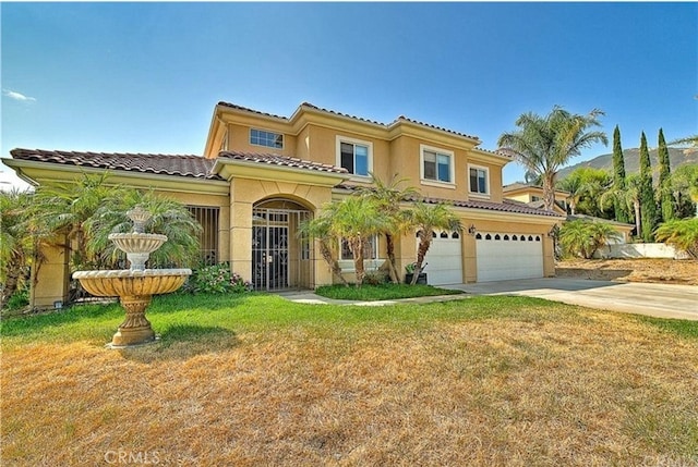 mediterranean / spanish house featuring an attached garage, stucco siding, concrete driveway, a front lawn, and a tile roof